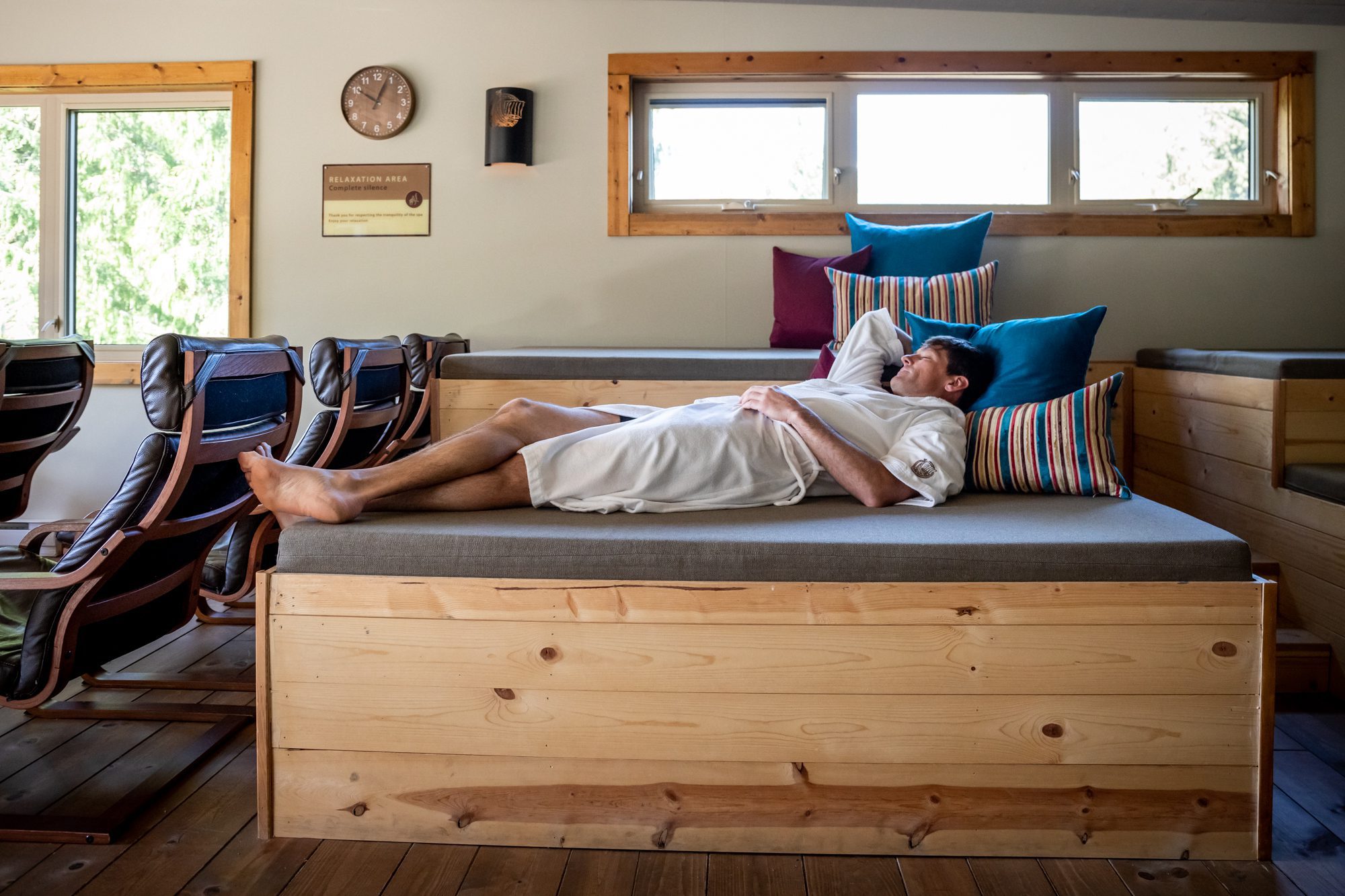 man in robe relaxing on lounge bed in a robe